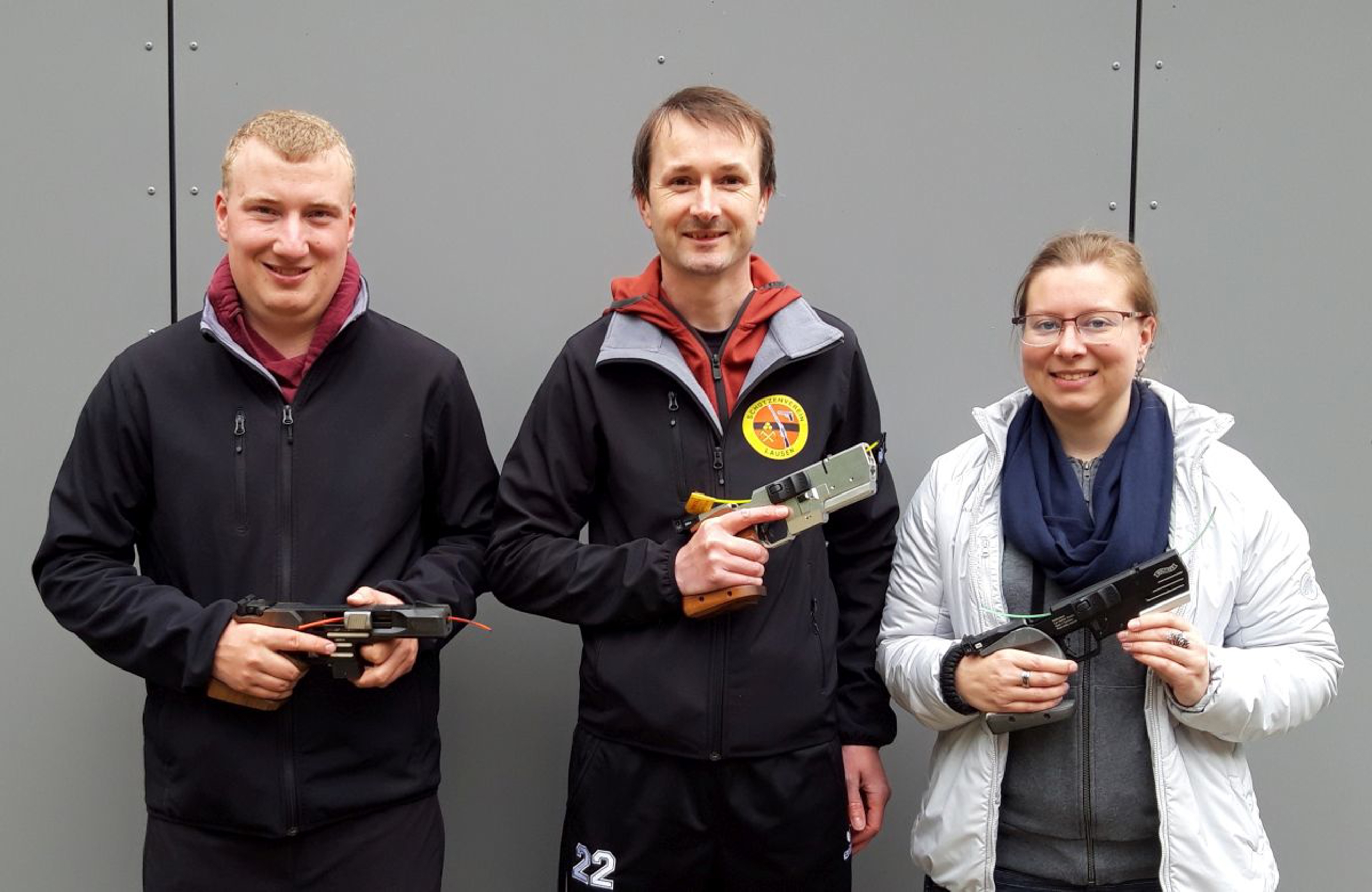 Das Siegertrio Pistole 25m mit ihren Sportgeräten (v.l.): 2. Adrian Schaub , 1. Philipp Wild, 3. Tanja Spiess.